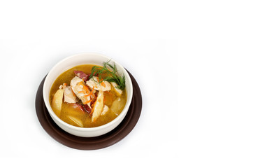 a bowl of brown soup on a white background