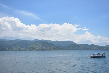Fototapeta na wymiar Boat on a lake with mountains