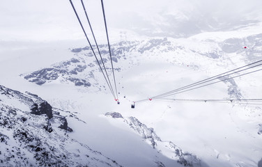 Riding the cable car in the mountains through a deep valley.