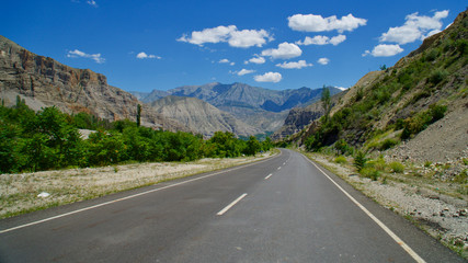 Curving roads in a green nature with pointed and steep rocks