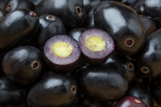 Fresh black Jamun berries full frame and halved ones