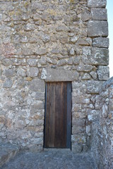 Fototapeta na wymiar Stone Castle Tower With Wooden Doorway In a Medieval Defense Fortress in Portugal