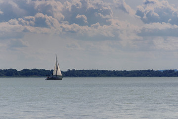 Sailing boat on beautiful lake Balaton, Hungary on a hot summer day, copy space.