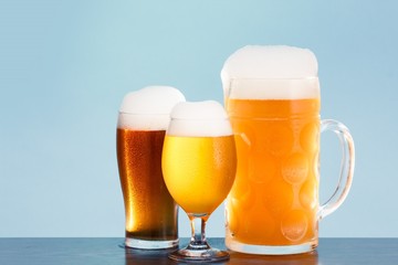 Golden beer in glass with foam, alcohol beverage,  lager pint.