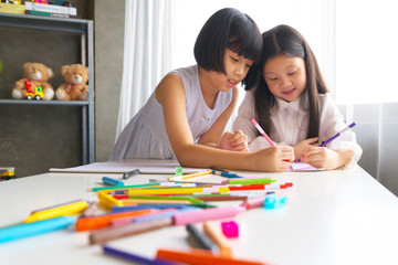 group of asian child little drawing with colourful pencils crayons in classroom. - 283222650