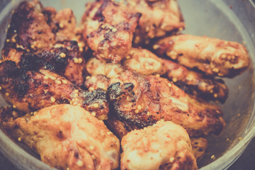 Grilled chicken wings in plate.