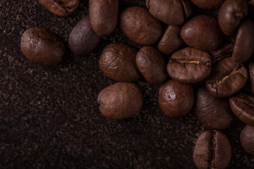 Coffee beans  on stone background. Top view with copy space for your text. Roasted coffee beans background. Beans texture, macro