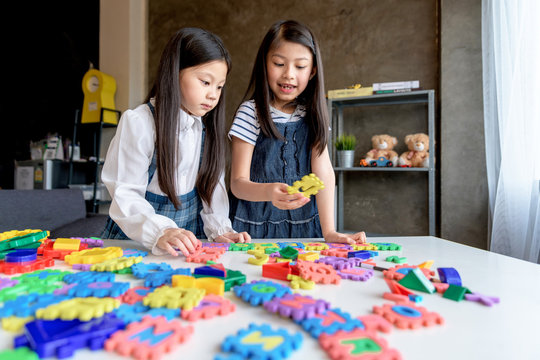 Asian Kids playing with puzzle, learning concept