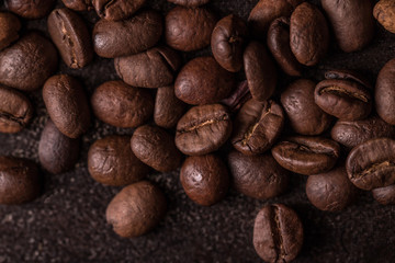 Coffee beans  on stone background. Top view with copy space for your text. Roasted coffee beans background. Beans texture, macro