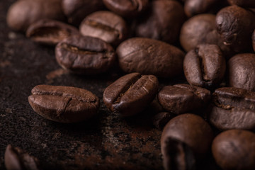 Coffee beans  on stone background. Top view with copy space for your text. Roasted coffee beans background. Beans texture, macro