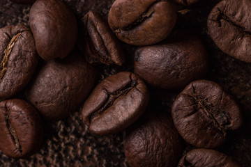 Coffee beans  on stone background. Top view with copy space for your text. Roasted coffee beans background. Beans texture, macro