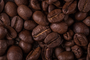 Coffee beans  on stone background. Top view with copy space for your text. Roasted coffee beans background. Beans texture, macro