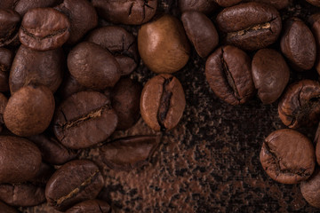 Coffee beans  on stone background. Top view with copy space for your text. Roasted coffee beans background. Beans texture, macro