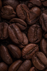 Coffee beans  on stone background. Top view with copy space for your text. Roasted coffee beans background. Beans texture, macro