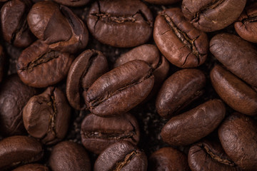 Coffee beans  on stone background. Top view with copy space for your text. Roasted coffee beans background. Beans texture, macro