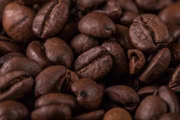 Coffee beans  on stone background. Top view with copy space for your text. Roasted coffee beans background. Beans texture, macro