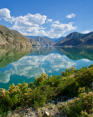 Naklejka na ściany i meble Erzurum, Tortum lake, cliff mountains and cloud reflection in water