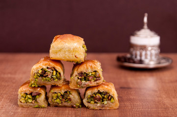 Baklawa on wooden table and Turkish coffee on background