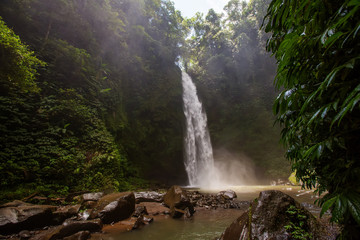 Nung-Nung Bali waterfall in rainforest.