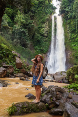 Fototapeta na wymiar Woman near waterfal Git Git on Bali, Indonesia 