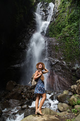 Woman near waterfal on Bali, Indonesia 