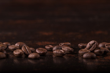 Coffee beans  on stone background. Top view with copy space for your text. Roasted coffee beans background. Beans texture, macro