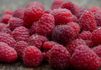 fresh raspberries on wooden background