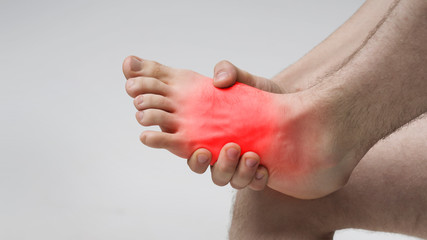 Pain in foot. Massage of male feet