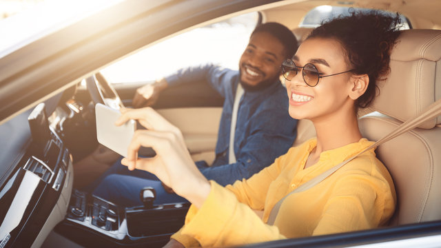 Happy African American Couple Taking Selfie In Car