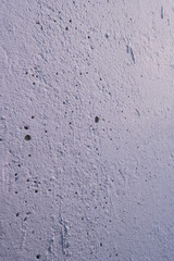 Cement wall with roughness, cracks and bumps. Abstract grunge background.