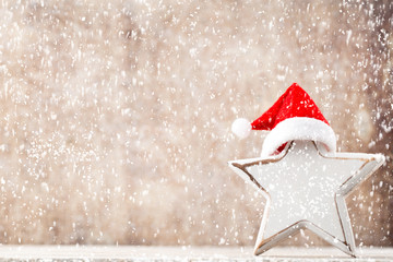 Christmas star with Santa hat. Vintages background.