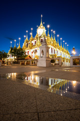 Fototapeta premium Wat Ratchanatdaram and Loha Prasat Metal Castle at twilight, landmark and famous place of Bangkok, Thailand