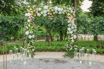 Wedding arch for ceremony outdoor with flower decoration and rustic design