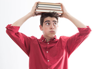 isolated student with books stacked on the head