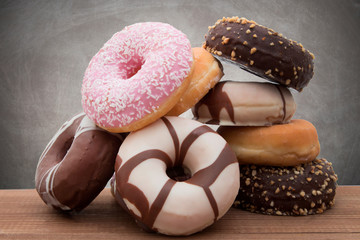 assorted donuts stacked on background
