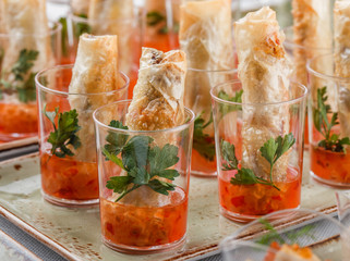 Delicious appetizers in glass cups on banquet table. Catering food, canape and snacks