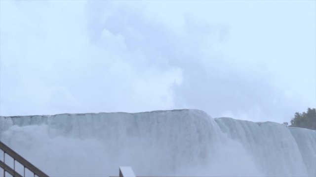 Niagara Falls water fall close up on a cloudy summer day. The edge of a massive water fall. Beautiful and majestic Niagara Falls close up. 