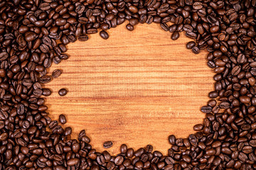 A coffee beans over wooden table top background.