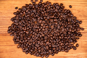 A coffee beans over wooden table top background.