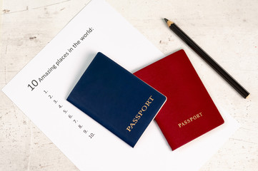 Blue and red travel passports on a light background, next to the inscription ten amazing places in the world.