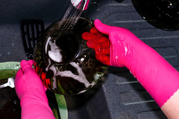 The process of washing plates in the sink, hands and plates closeup. Detergent foams. Cleaning.