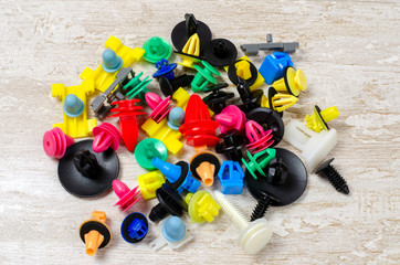 mounting plastic pistons of different colors on a light background