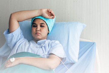 Asian female patient Which is cancer, lying in the patient's bed Are stressed From the process of treating their own diseases, to health care and insurance concept.