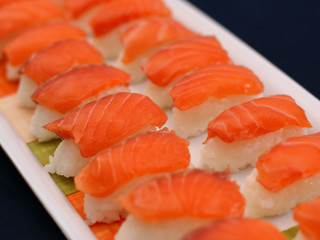 Niguiri sushi is an elongated rice ball with a piece of raw fish or any other ingredient on top. Sometimes, so that the ingredient does not move, a strip of nori seaweed is placed to hold it.