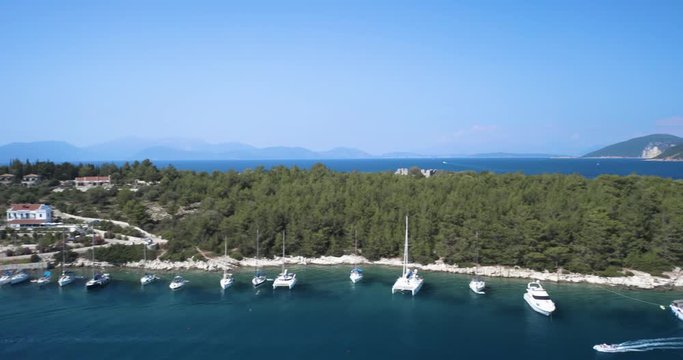 Isolated scenic mythical Ithaca island at Fiscardo port, wide panning shot