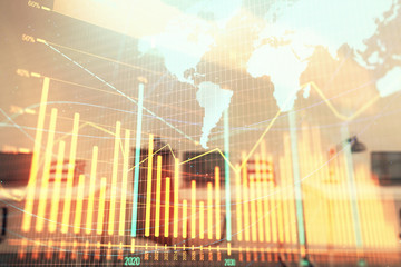 Stock and bond market graph and world map with trading desk bank office interior on background. Multi exposure. Concept of international finance
