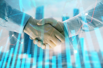 Double exposure of financial chart and world map on cityscape background with two businessmen handshake. Concept of international investment
