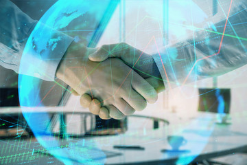 Multi exposure of financial chart and map on office background with two businessmen handshake. Concept of success in business