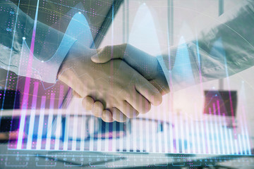 Multi exposure of financial graph on office background with two businessmen handshake. Concept of success in business