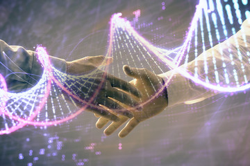 Multi exposure of DNA hologram on abstract background with two men handshake. Concept of...